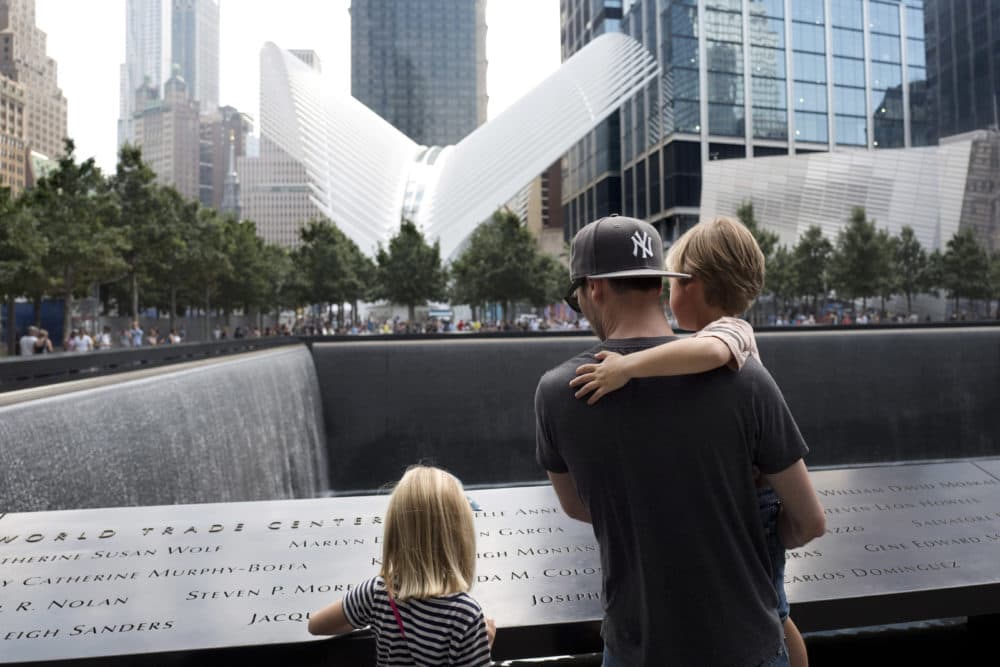 Mikal Petersen and his children, Elle, 7, and Jude, 4, looked at the North Pool of the National September 11 Memorial on Sept. 5, 2017, in New York. &quot;I tell them this represents a building that once stood here, where many people lost their lives, and that now it is a sacred spot,&quot; said Petersen. (Mark Lennihan/AP)
