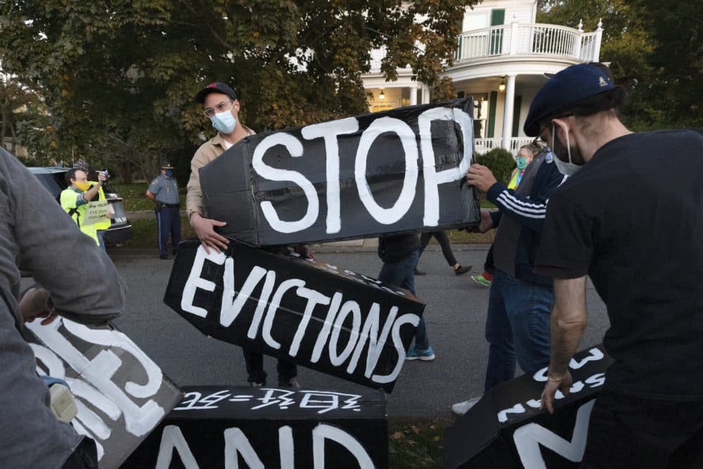 In this Oct. 14, 2020, file photo, housing activists erect a sign in front of Gov. Charlie Baker's house in Swampscott, Mass. (Michael Dwyer/AP)