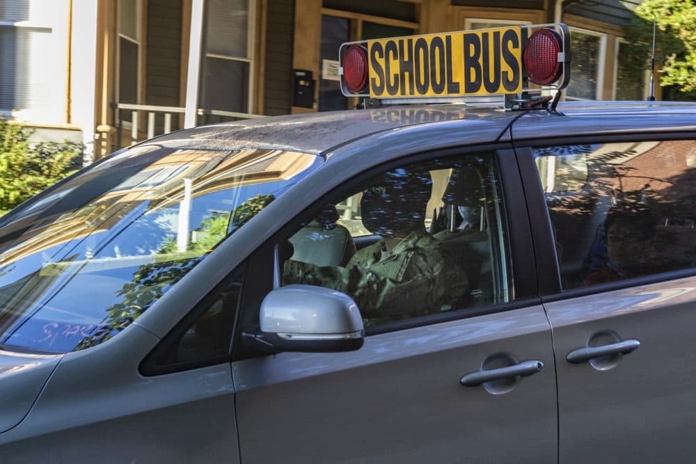 A National Guard member drives a school bus van in Chelsea. (Jesse Costa/WBUR)