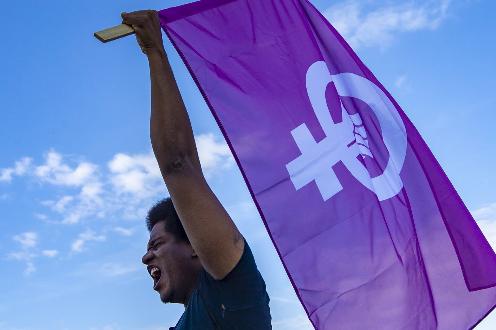 Stevie Downie cheers and raises a women’s rights flag during the Boston Rally to Defend Abortion at the Franklin Park Playstead. (Jesse Costa/WBUR)