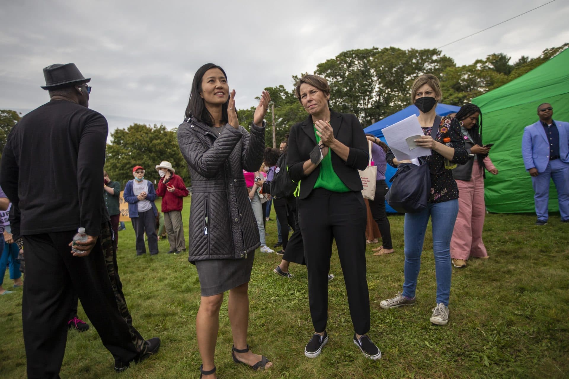 Boston mayoral candidate Michelle Wu and Attorney General Maura Healey applaud during a speech. (Jesse Costa/WBUR)