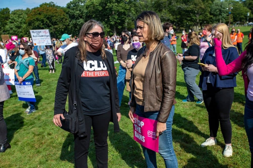 ACLU Director Carol Rose and City Councilor Annissa Essaibi George spak to each other during the Boston Rally to Defend Abortion at. the Franklin Park Playstead where at least 1000 people gathered to rally as part of nationwide protests happening to defend abortion rights. (Jesse Costa/WBUR)