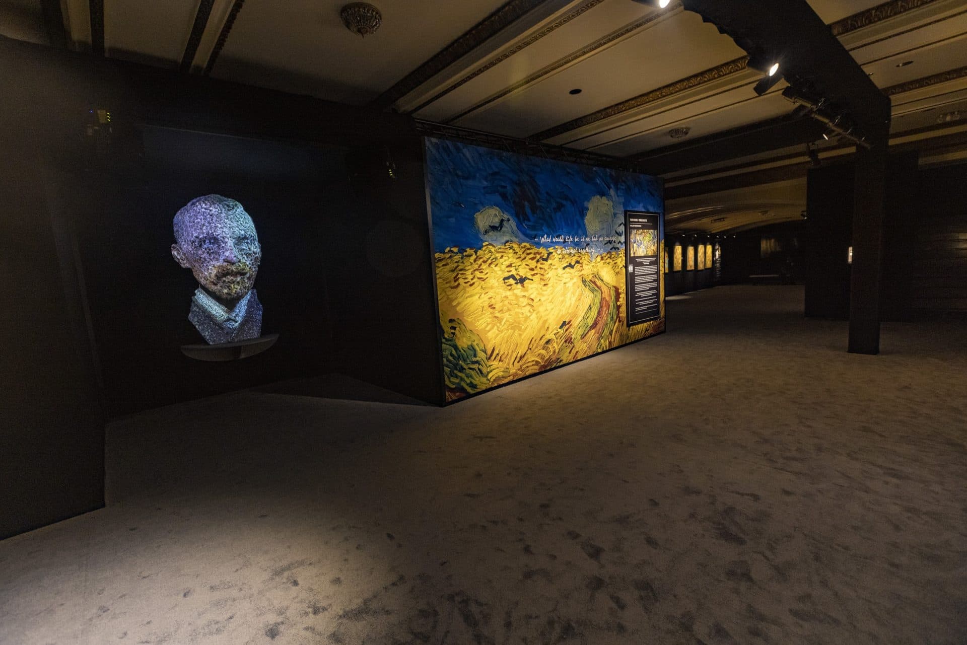 At the beginning of the exhibit, a bust of Vincent van Gogh is painted with various colors of light. (Jesse Costa/WBUR)