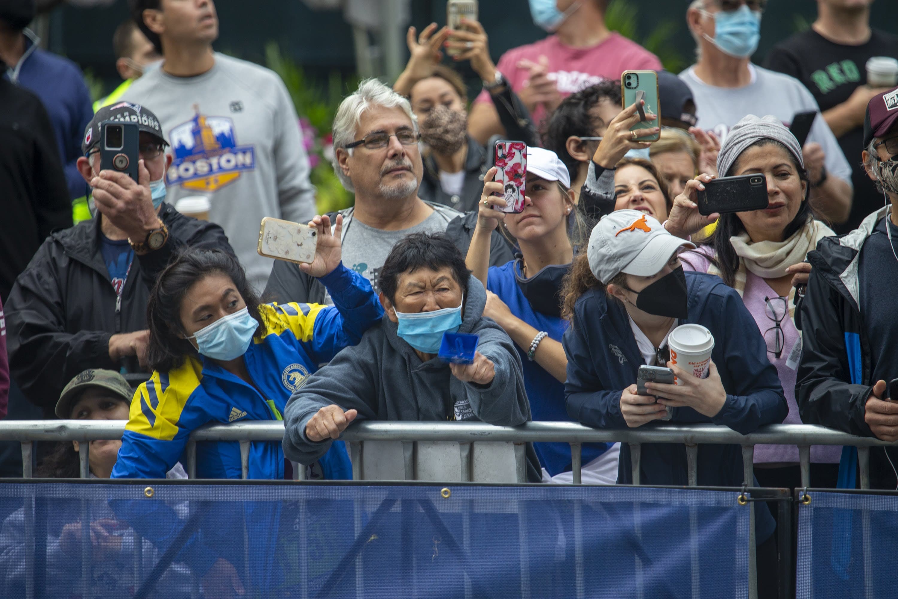 Spectators at the Boston Marathon cheer along Boyston Street as racers approach the finish line. (Jesse Costa/WBUR)