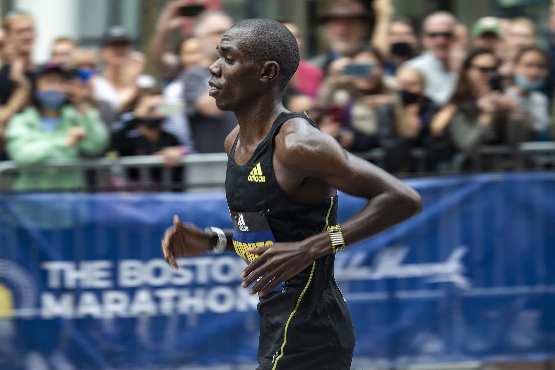 Boston Marathon men’s leader Benson Kipruto approaches the finish line at mile 26 on Boylston Street. (Jesse Costa/WBUR)