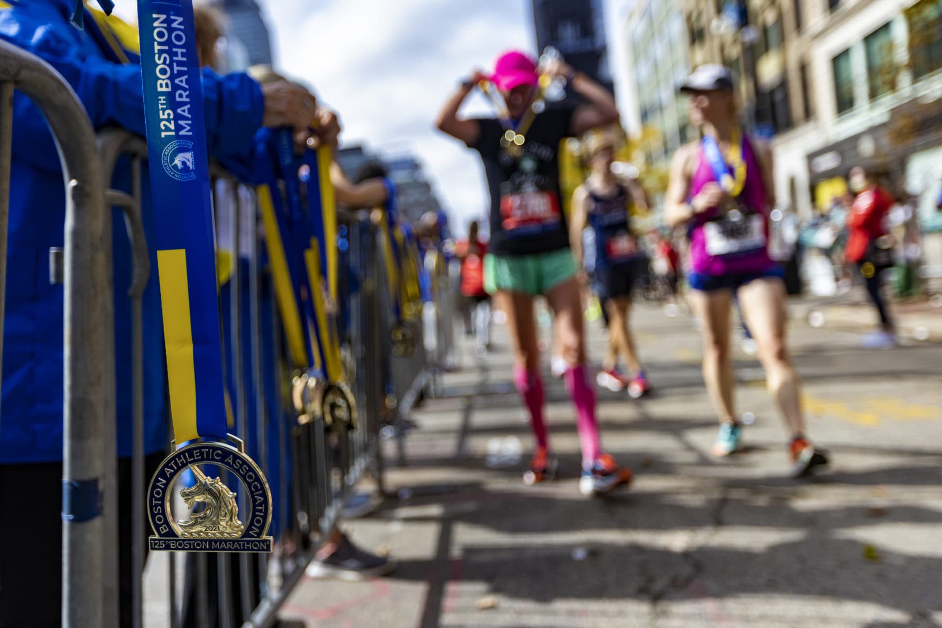 Boston Marathon participants receive their medals after they finished the grueling 26.2 mile course. (Jesse Costa/WBUR)