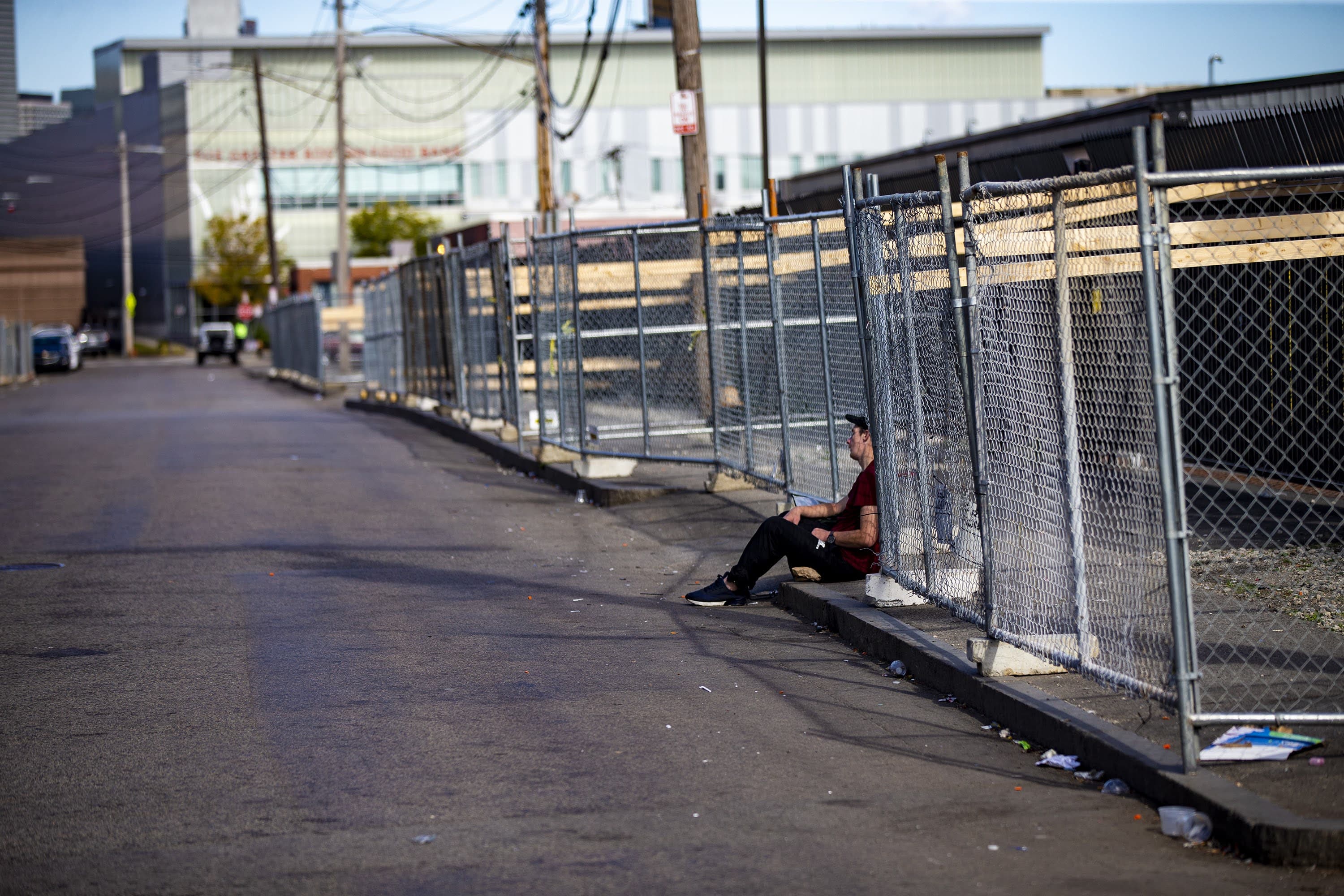 Fencing and barriers are placed along the sidewalks of Topeka Street to deter people from putting up tents along the street. (Jesse Costa/WBUR)