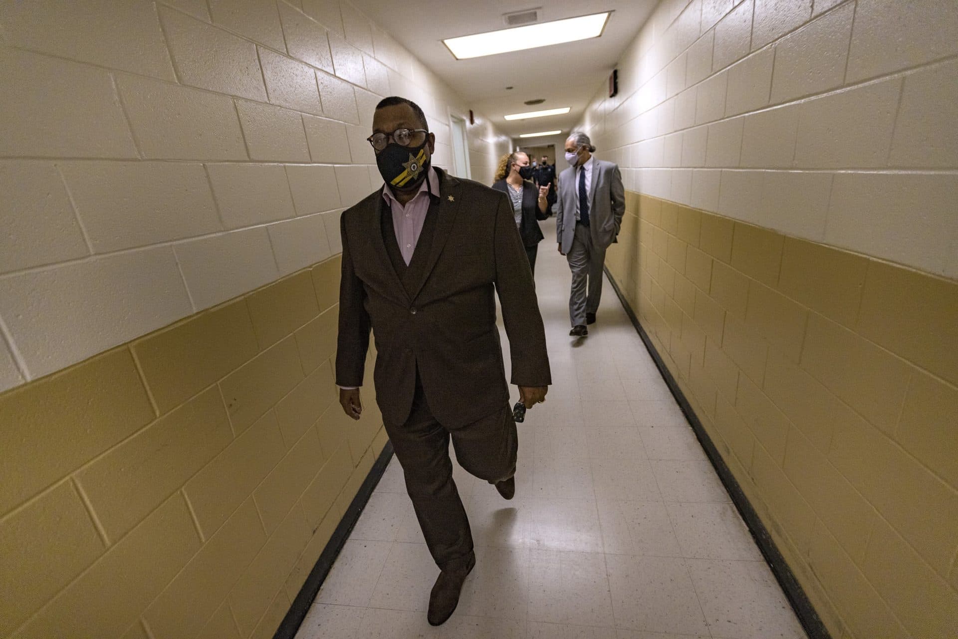 Sheriff Steven Tompkins walks through a hallway of the Suffolk County jail during a tour of the facility. (Jesse Costa/WBUR)