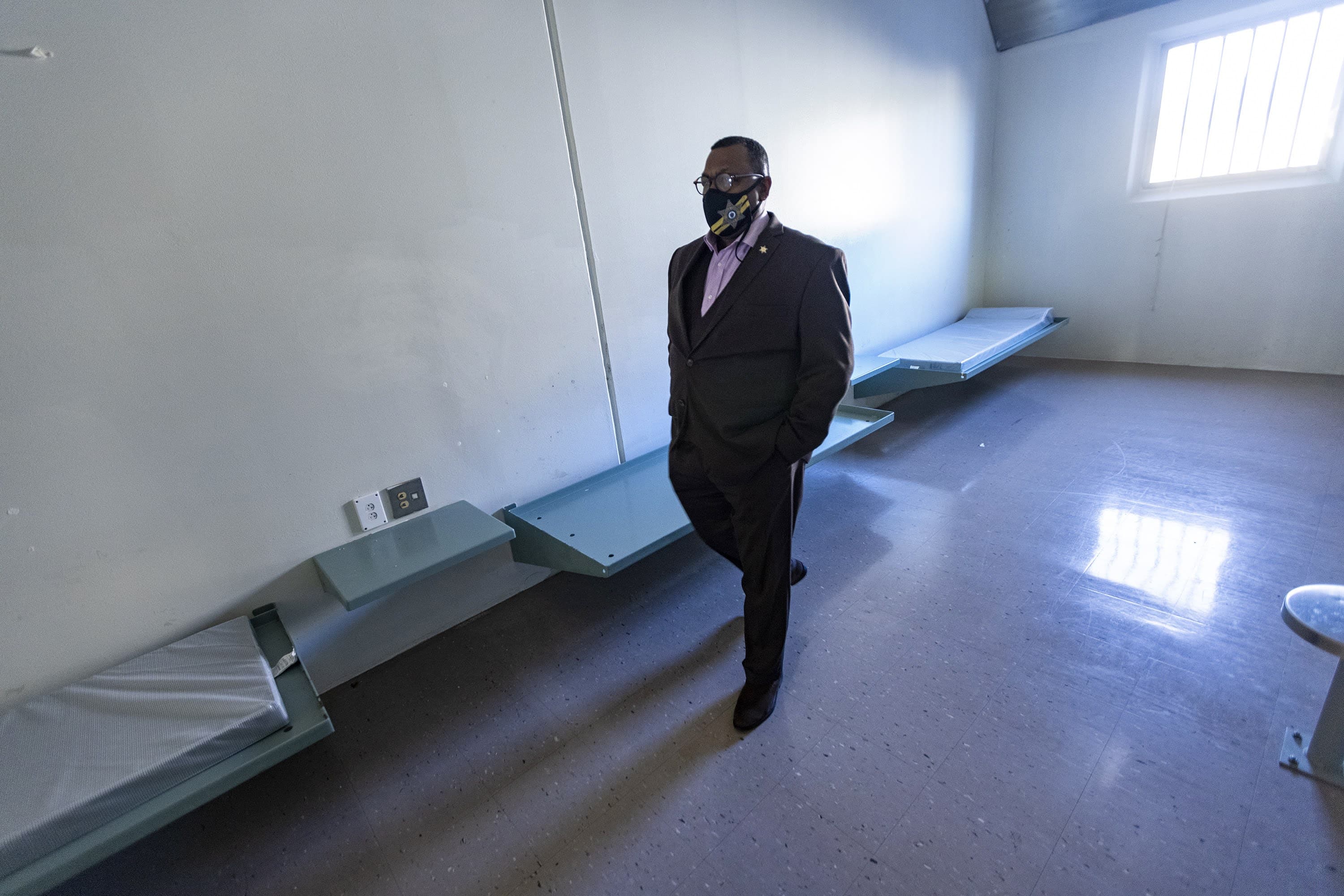Sheriff Steven Tompkins walks through one of the jail cells he says will be turned into a room that will house some people without homes who live in tents around Boston's so-called &quot;Mass. and Cass&quot; area. (Jesse Costa/WBUR)