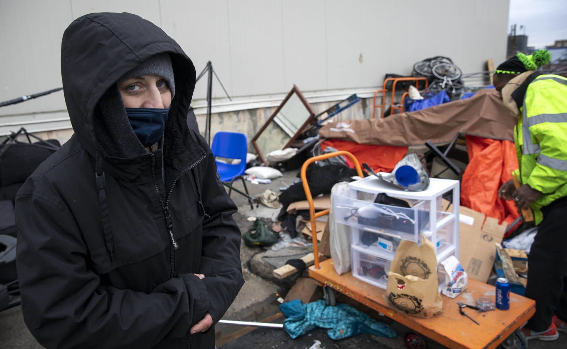 Samantha Kardas sorted through her storm-damaged shelter before a BPHC crew cleared the Southampton Street sidewalk where it stood on Thursday. (Robin Lubbock/WBUR)