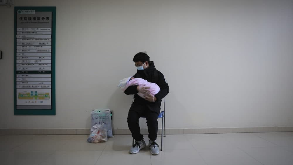 Father holds his newborn baby in hospital during the peak of the COVID-19 outbreak in Wuhan, China. Seen in &quot;76 Days.&quot; (MTV Documentary Films)