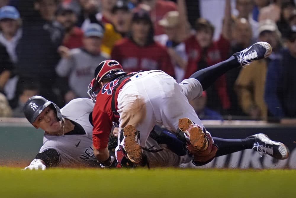 New York Yankees' Aaron Judge (99) is tagged out at the plate by Boston Red Sox catcher Kevin Plawecki as he tries to score on a single by Giancarlo Stanton in the sixth inning of an American League Wild Card playoff baseball game at Fenway Park, Oct. 5, 2021. (Charles Krupa/AP)
