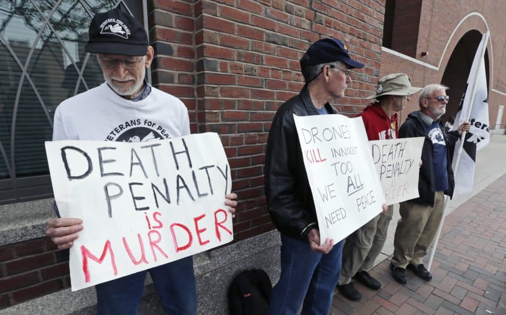 A group from &quot;Veterans for Peace&quot; picketed outside the Moakley Federal Courthouse as jurors deliberated in the penalty phase of the trial of Boston Marathon bomber Dzhokhar Tsarnaev, Friday, May 15, 2015. (Charles Krupa/AP)