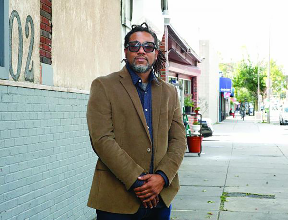 Cleon Byron in front of the upcoming Evoke cannabis dispensary at 1102A Blue Hill Ave., an area where he has lived his entire life. (Seth Daniel/The Dorchester Reporter)