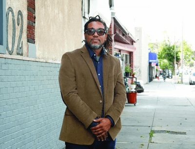 Cleon Byron in front of the upcoming Evoke cannabis dispensary at 1102A Blue Hill Ave., an area where he has lived his entire life. (Seth Daniel/The Dorchester Reporter)