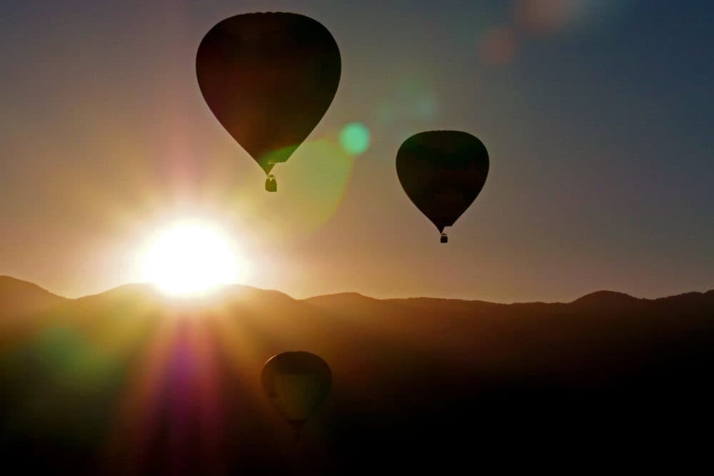 Balloons fly over the Sandia Mountains during a Mass Ascension during the Albuquerque International Balloon Fiesta in Albuquerque, New Mexico. (Maddie Meyer/Getty Images for Lumix)