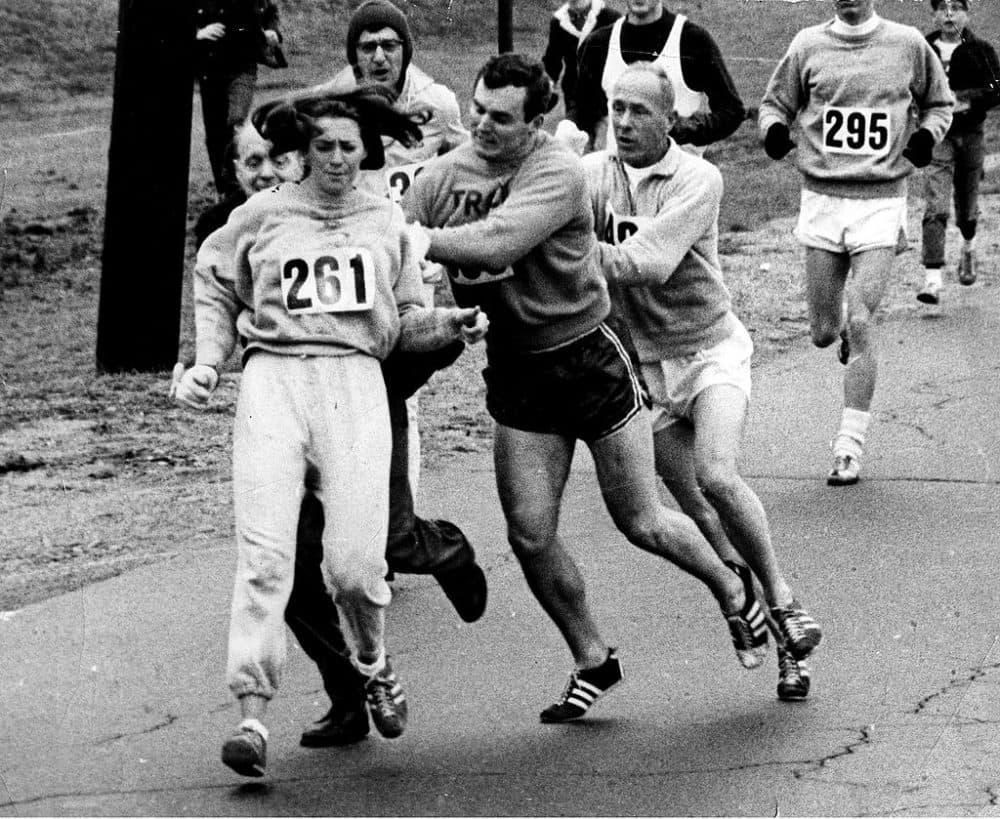 Kathrine Switzer outruns Jock Semple, dressed in street clothes, during Boston Marathon on April 19, 1967. (Paul J. Connell/The Boston Globe via Getty Images)