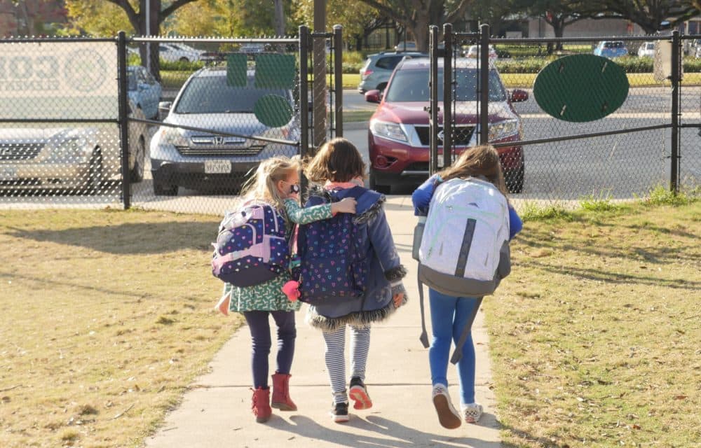 School children wearing facemasks walk outside Condit Elementary School in Bellaire, outside Houston, Texas. (FRANCOIS PICARD/AFP via Getty Images)