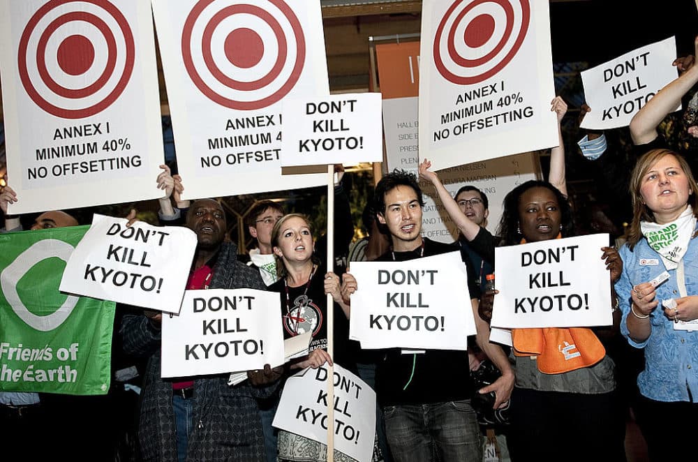 Demonstrators hold placards during a protest inside the Bella Center during the Climate Change summit in Copenhagen on Dec. 10, 2009. Poor countries have challenged President Barack Obama as he received his Nobel Prize to steer the U.S. back into the Kyoto Protocol. (Keld Navntoft/AFP/Getty Images)
