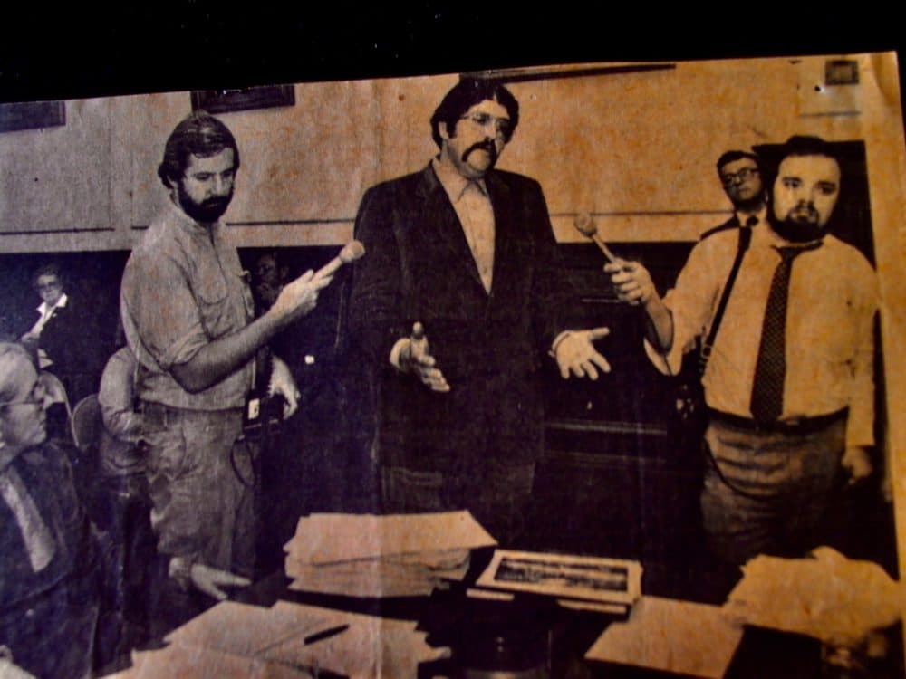 In this photo taken in the 1980s, then-New Hampshire Public Radio reporter Sam Fleming, far left, and Bob Oakes, far right, then a CBS radio station reporter, interview a politician at the New Hampshire State House in Concord, N.H. (Courtesy Sam Fleming)