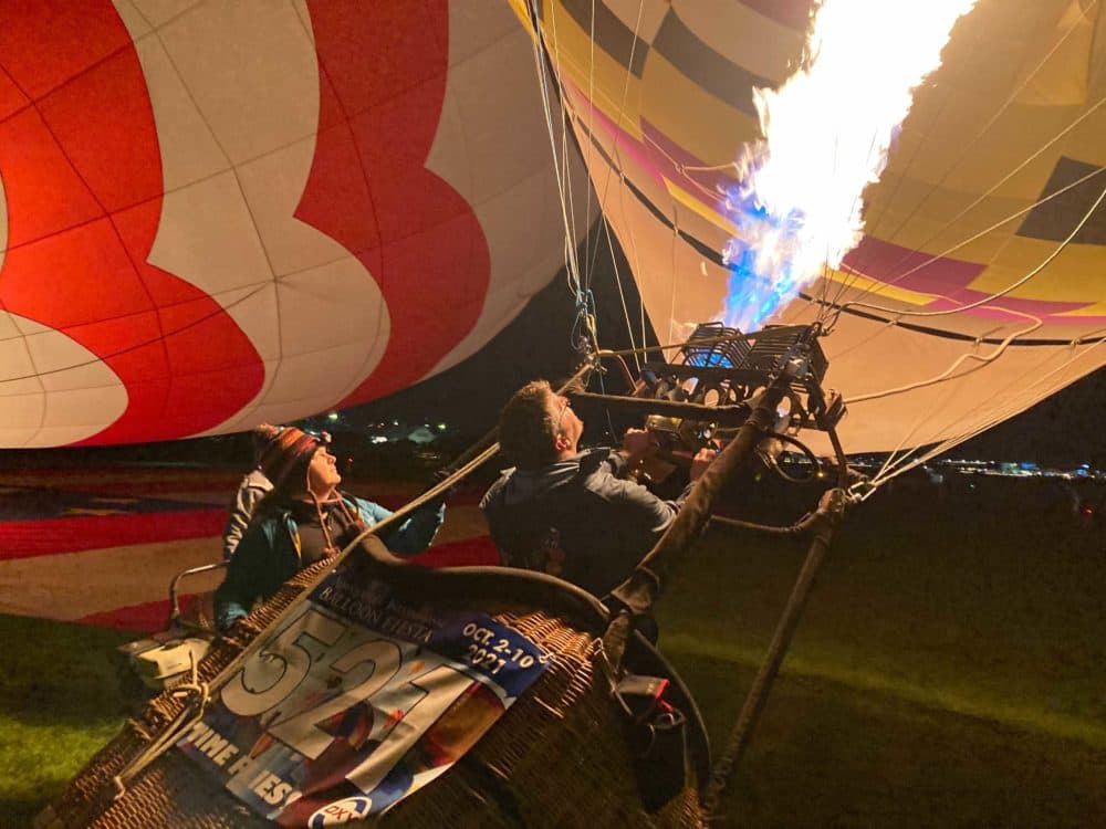 Members of the Albuquerque Balloon Fiesta’s Dawn Patrol inflate their balloons ahead of the morning’s first launch. (Peter O'Dowd/Here &amp; Now)