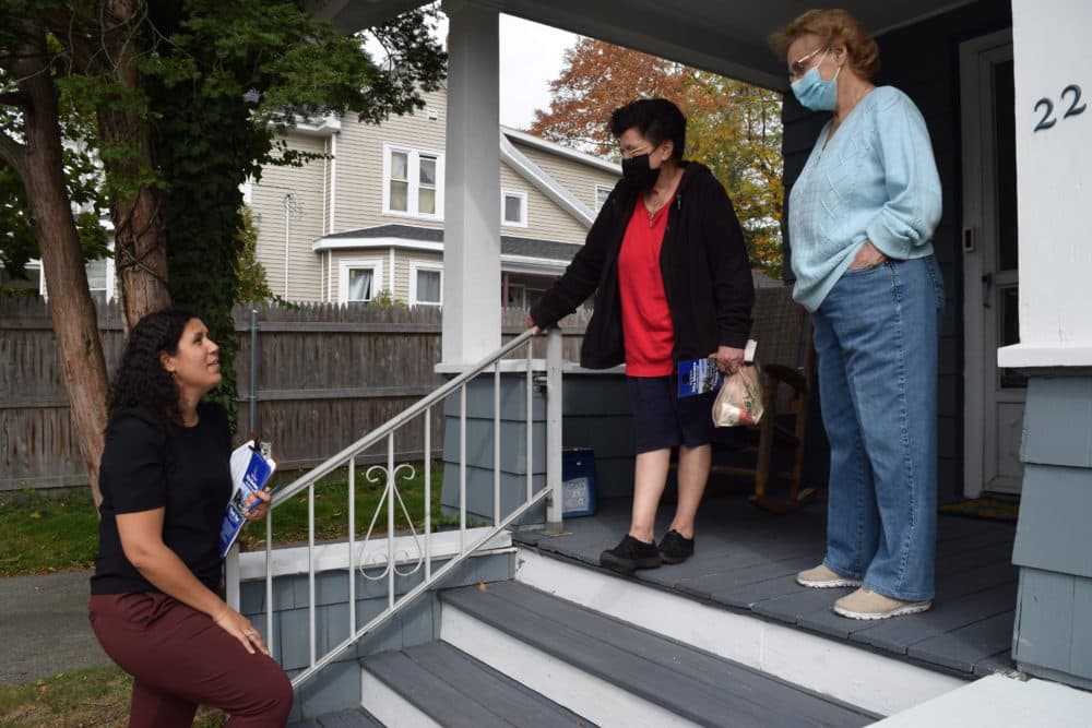 Brockton At-Large City Councilor Rita Mendes talks with voters Theresa Gonzalez and Nancy Glenn about the upcoming municipal election, and about changes coming to the city because of legislative redistricting. (Steve Brown/WBUR)