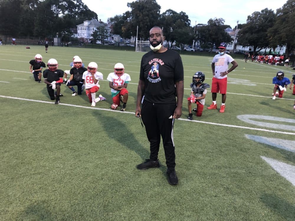 Mick Brunache, who coaches a Pop Warner football team in Mattapan. (Anthony Brooks/WBUR)