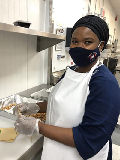 Chef Mariama bagging nuts. (Karyn Miller-Medzon/Here &amp; Now)