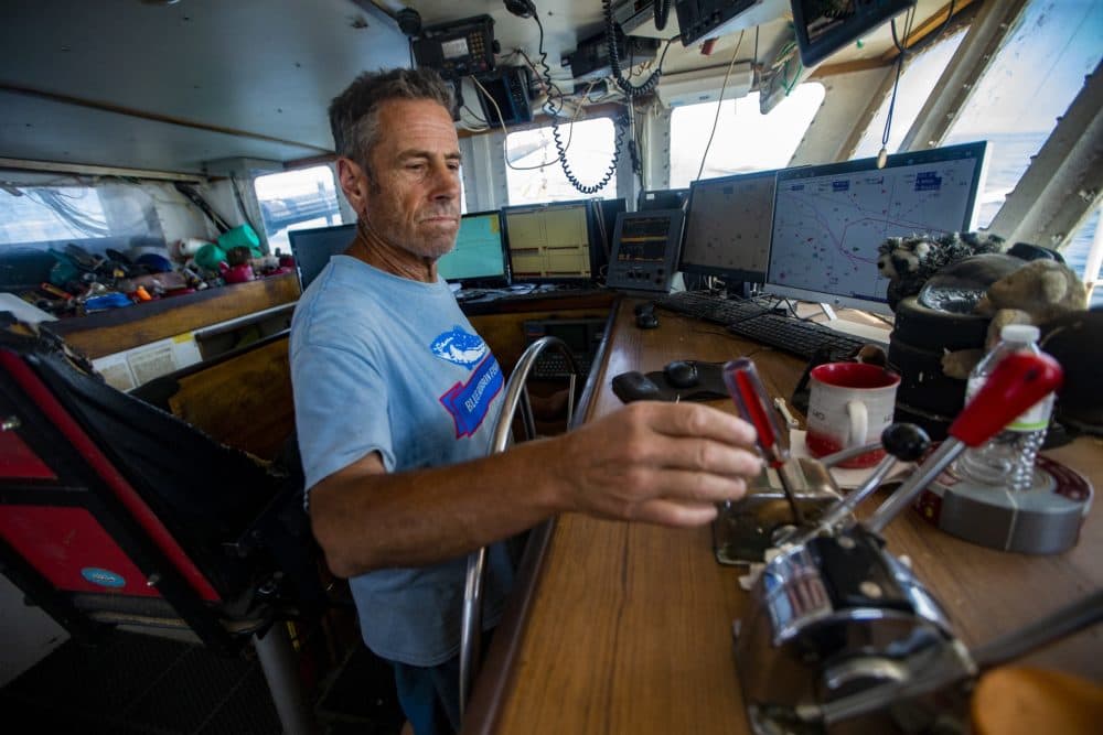 Dave Aripotch reaches for the throttle to begin the Caitlin &amp; Mairead’s second pass at trawling for more squid. (Jesse Costa/WBUR)