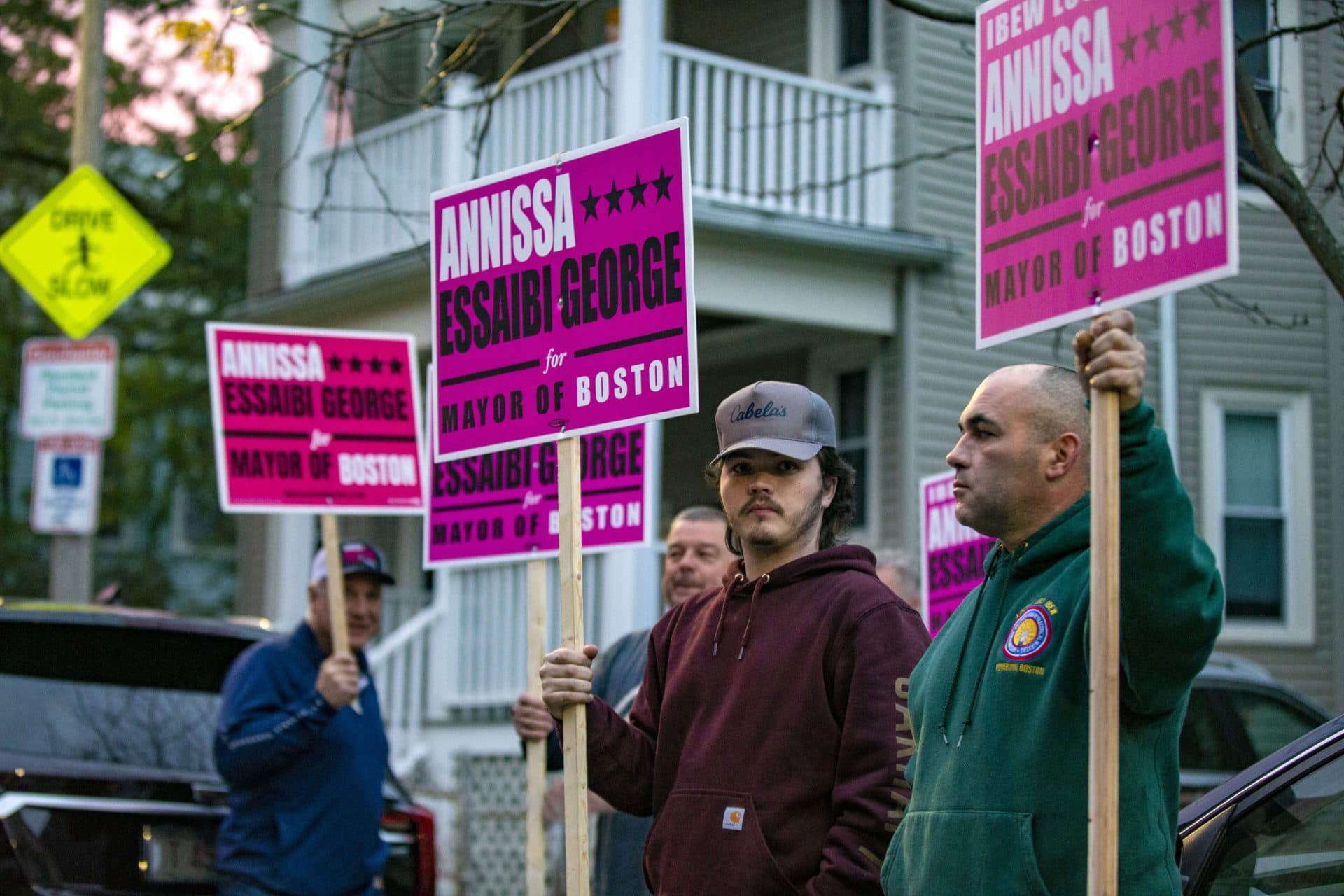 Supporters for Annissa Essaibi George hold signs outside of the Bellflower Apartments in Dorchester where the candidate voted. (Jesse Costa/WBUR)