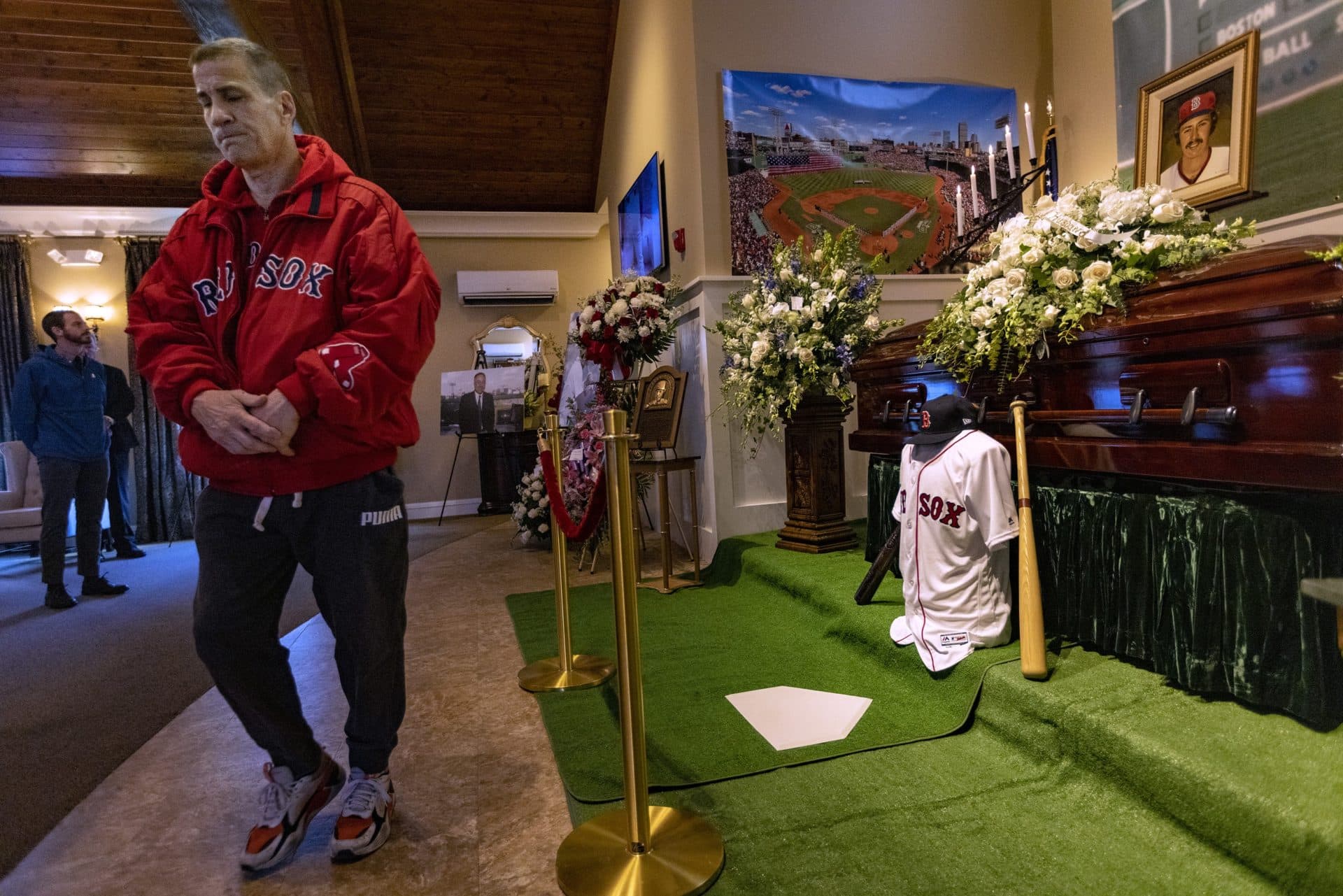 Brett Juliano of Watertown walks away after paying his respects to Red Sox great Jerry Remy during the memorial at the Mary Catherine Chapel of Brasco &amp; Sons Memorial in Waltham. (Jesse Costa/WBUR)