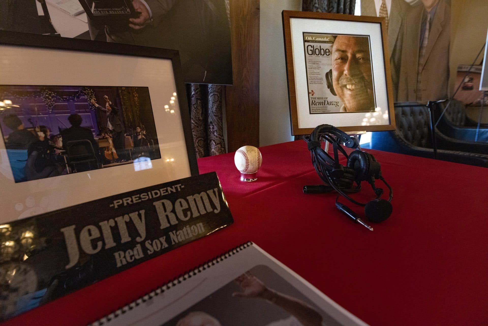 A signed baseball and a headset Remy wore while working as a broadcaster for the Red Sox were among the many items on display to memorialize him. (Jesse Costa/WBUR)