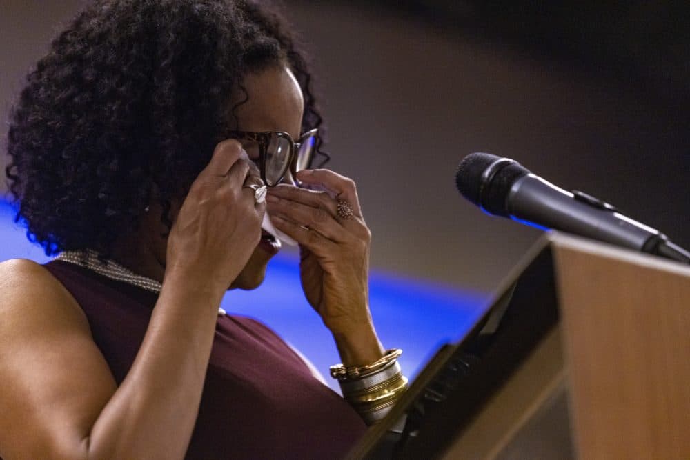 Janey wipes away a tear with a tissue. (Jesse Costa/WBUR)