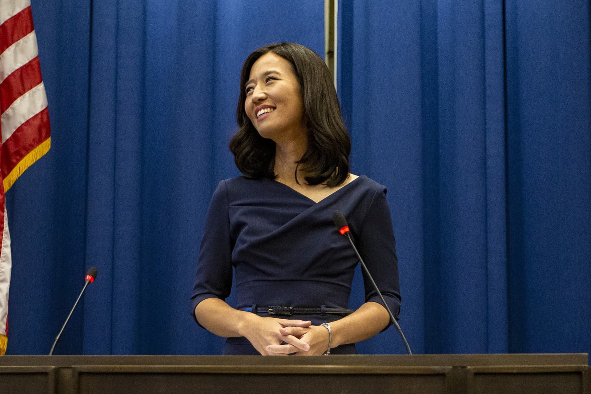 Michelle Wu smiles as she takes the podium to address the City Council Chamber as the new mayor of Boston. (Jesse Costa/WBUR)
