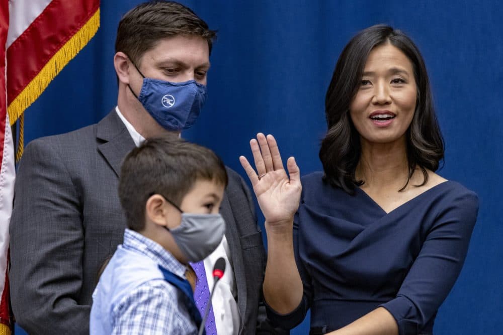 With her family by her side, Michelle Wu takes the oath of office as mayor of Boston. (Jesse Costa/WBUR)