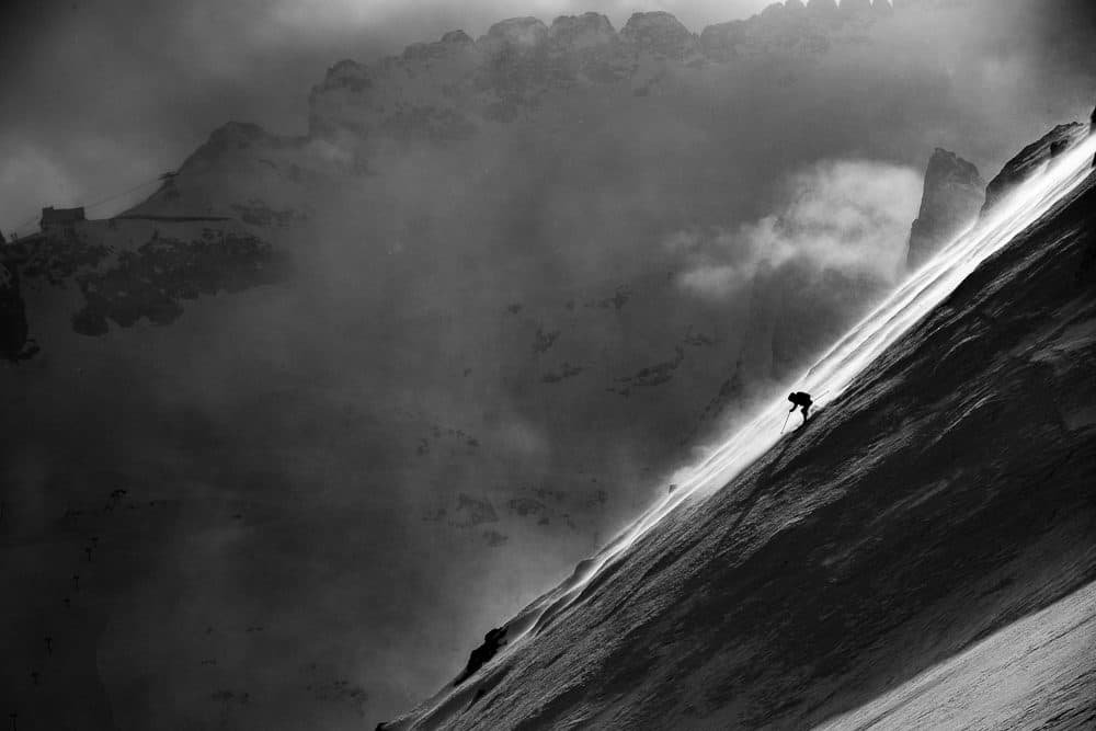 Skiing in hurricane-force winds near Italy's Marmolada Glacier, the last glacier in the Dolomites. The Marmolada shrank by a third and saw its surface area reduced by a fifth in just eleven years, between 2004 and 2015. (David Reddick)