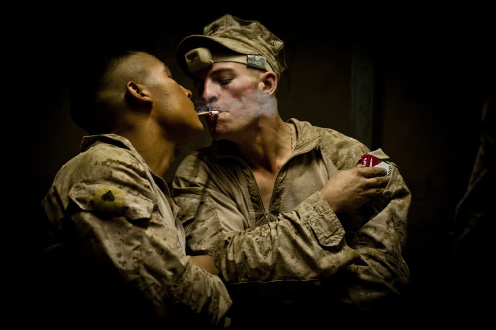 Lance Corporal John Bohlinger, right, lights a cigarette off of Corporal Manuel Mendoza's. (Elliott Woods)