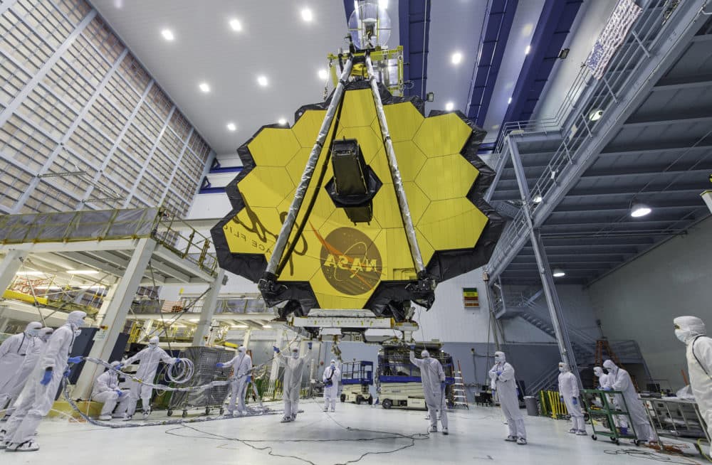 In this April 13, 2017 photo provided by NASA, technicians lift the mirror of the James Webb Space Telescope using a crane at the Goddard Space Flight Center in Greenbelt, Md. (Laura Betz/NASA via AP)