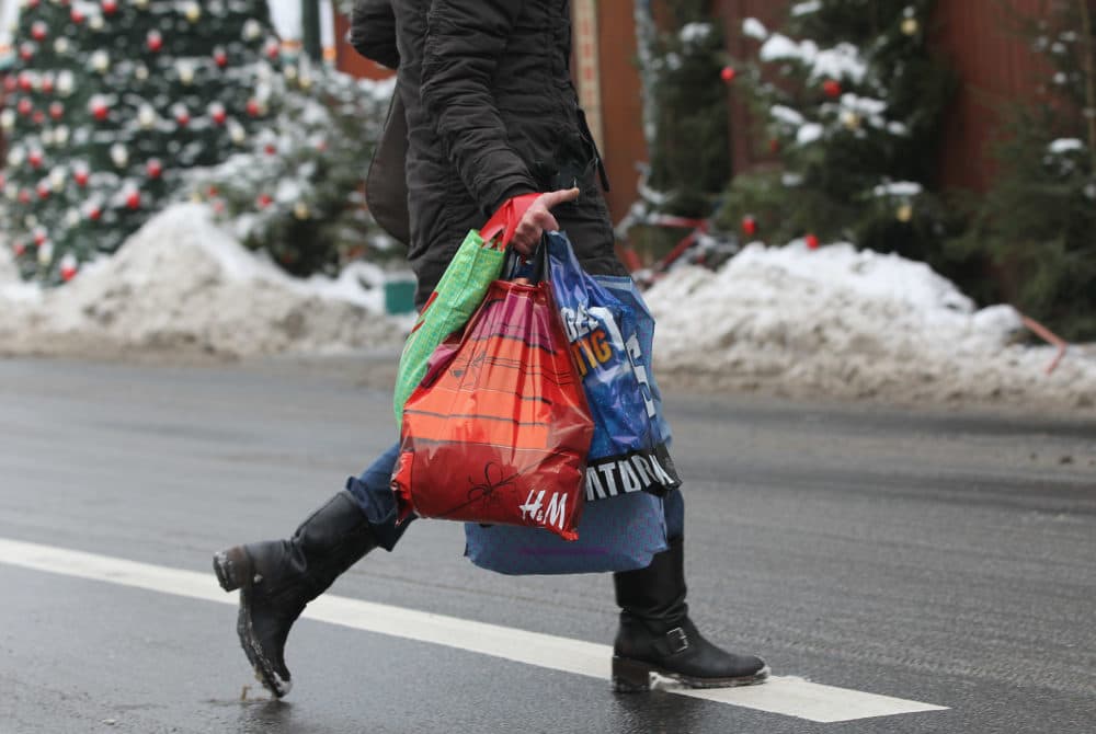 A woman carries shopping bags two days before Christmas. (Sean Gallup/Getty Images)