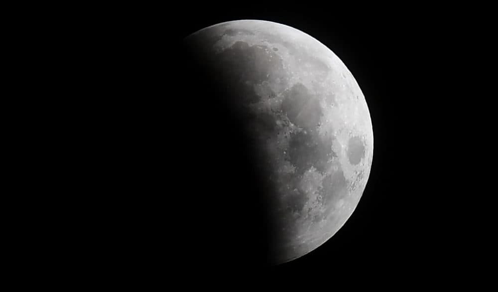 The eclipse of the moon progresses on May 26, 2021, in Santa Monica, California, on its way to the &quot;Super Blood Moon&quot; total eclipse. (Frederic J. Brown/AFP/Getty Images)
