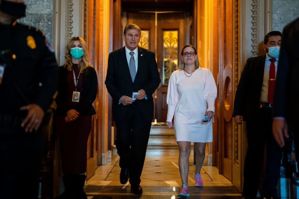 Sen. Joe Manchin (D-WV) leaves the Senate Chamber with Sen. Kyrsten Sinema (D-AZ) following a vote in the Senate at the U.S. Capitol Building on Wednesday, Nov. 3, 2021 in Washington, DC. Senate Republicans blocked debate on the John R. Lewis Voting Rights Advancement Act. (Kent Nishimura/ Los Angeles Times via Getty Images)