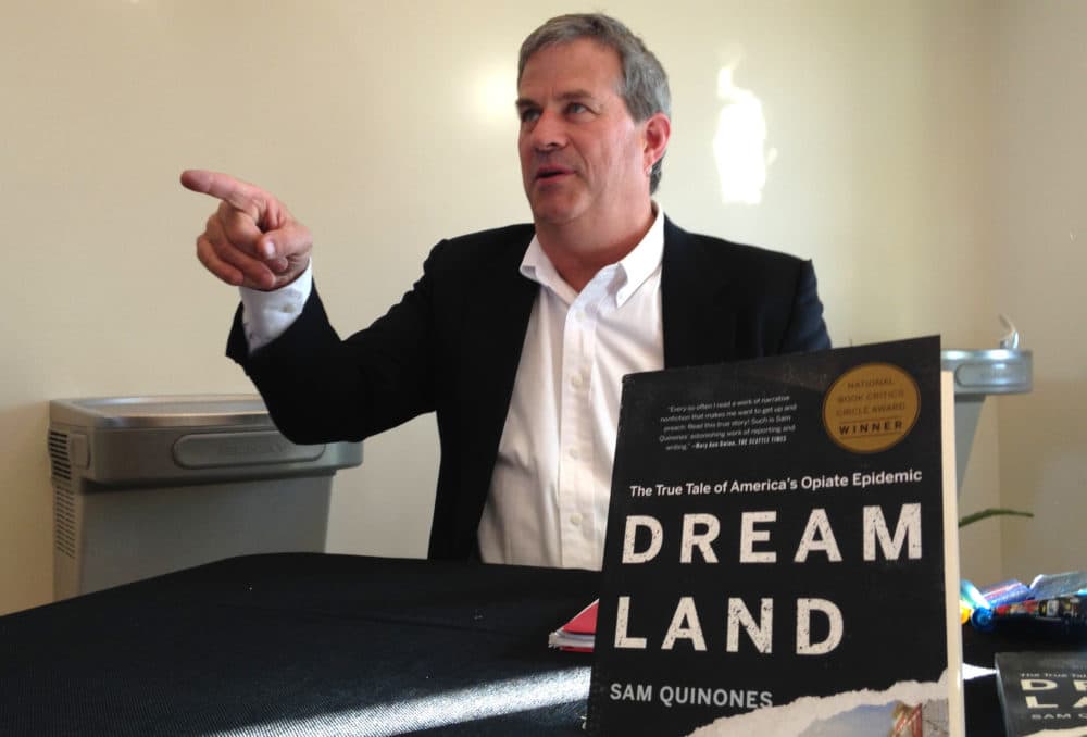 In this 2016 file photo author Sam Quinones signs copies of his book &quot;Dreamland: The True Tale of America's Opiate Epidemic&quot; in Albuquerque, New Mexico. (Mary Hudetz/AP)