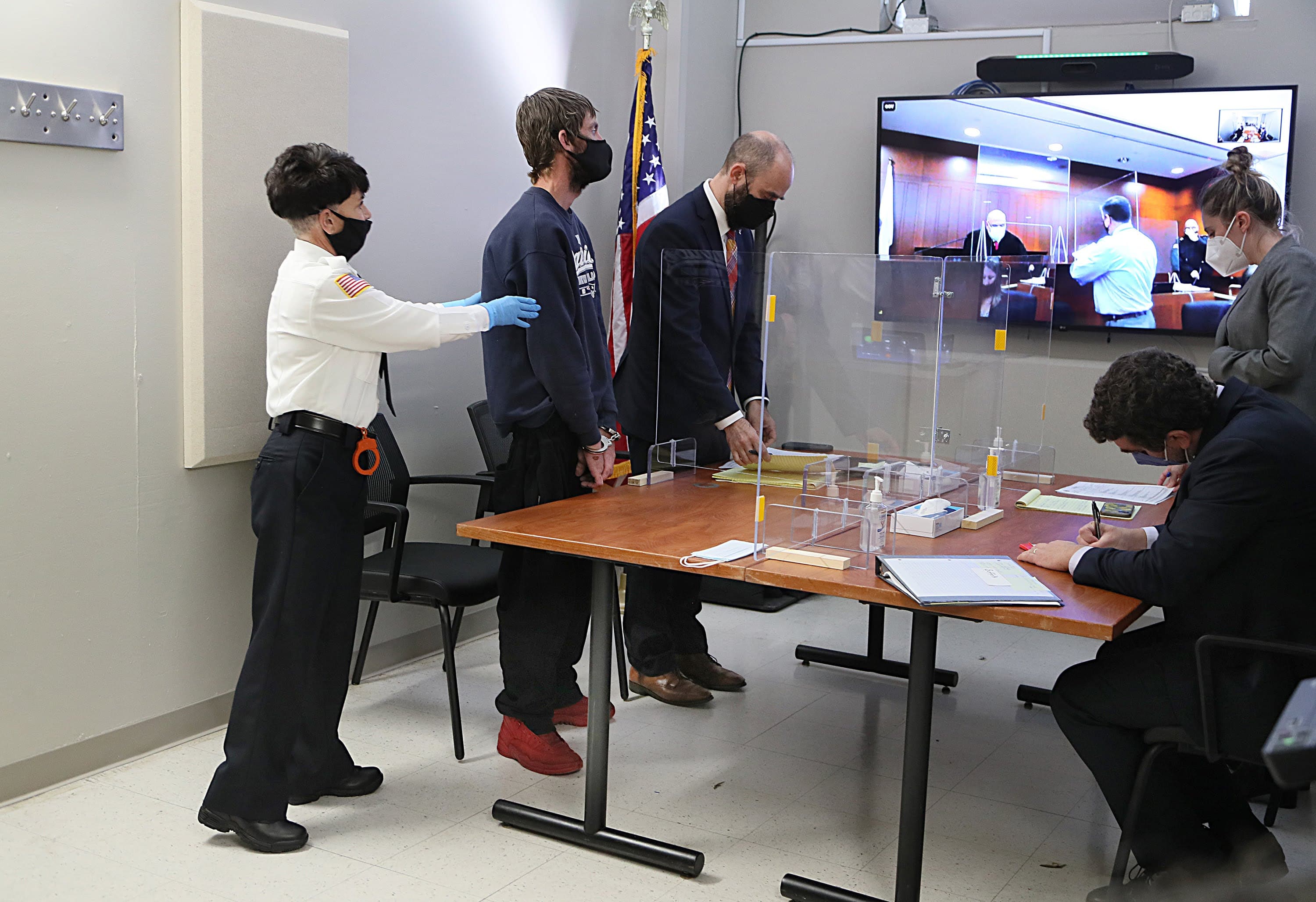 In the courtroom of the "Community Response Session" held at the Suffolk County House of Correction, a defendant made his first appearance after he was arrested inside the encampment area known as "Mass. and Cass." (Suzanne Kreiter/Boston Globe)