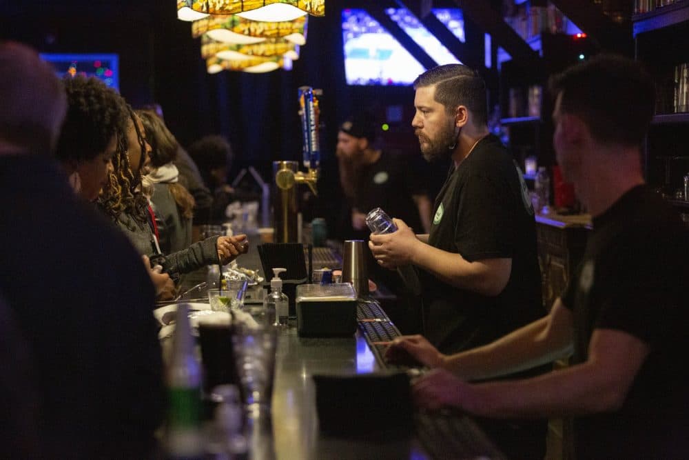 Cantab Lounge bartender Chris Buchanan talks with a customer. (Robin Lubbock/WBUR)