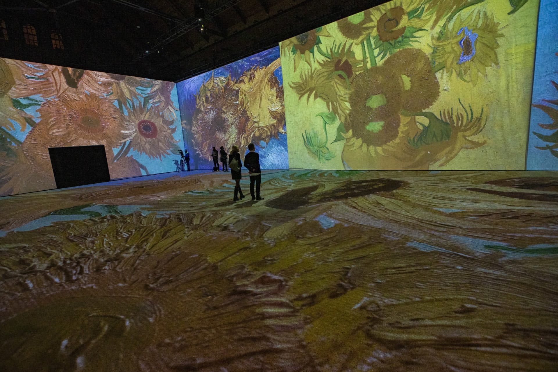 Vincent van Gogh’s &quot;Sunflowers&quot; projected onto the walls and floor during a press preview of &quot;Imagine Van Gogh&quot; at the SoWa Power Station in the South End. (Jesse Costa/WBUR)