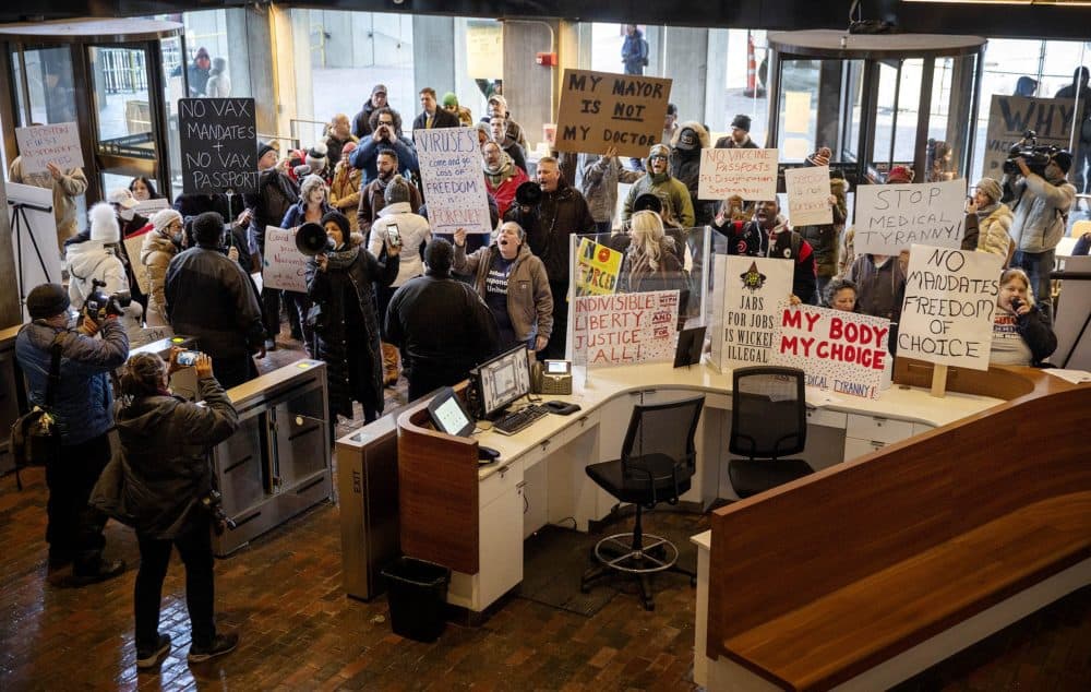Protesters chant &quot;Shame on Wu&quot; during Mayor Wu's announcement that vaccines would be required to enter many indoor venues in Boston. (Robin Lubbock/WBUR)