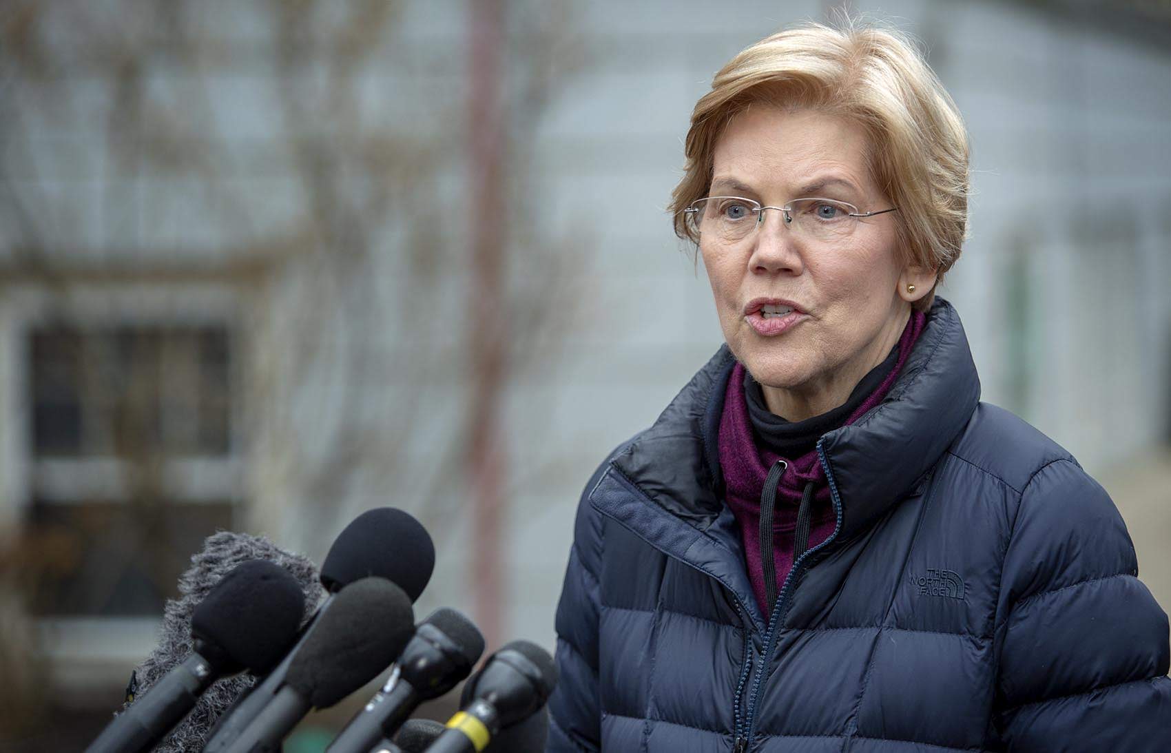 Sen. Elizabeth Warren talks with reporters outside her home in Cambridge in 2018. (Robin Lubbock/WBUR)