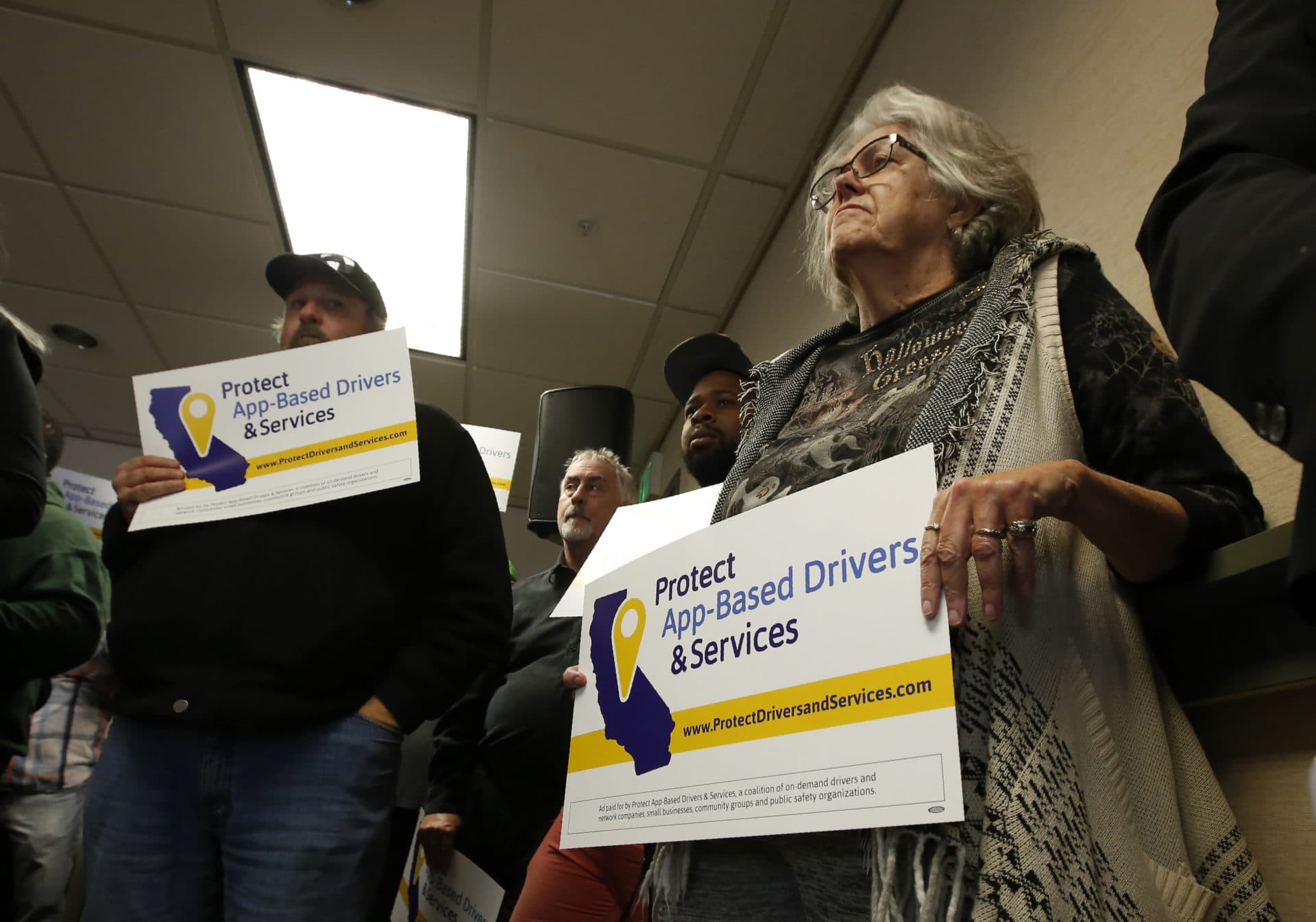 n this Oct. 29, 2019, file photo, Carla Shrive, right, who drives for various companies, joined other drivers to support a proposed ballot initiative challenging a recently signed law that makes it harder for companies to label workers as independent contractors, in Sacramento, Calif. (Rich Pedroncelli/AP File)
