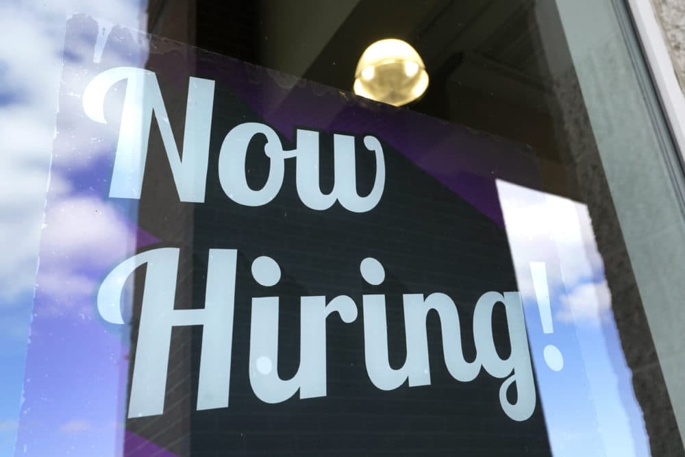 A &quot;Now Hiring&quot; sign is displayed on a business window, Thursday, March 4, 2021, in Salem, N.H. (AP Photo/Elise Amendola)