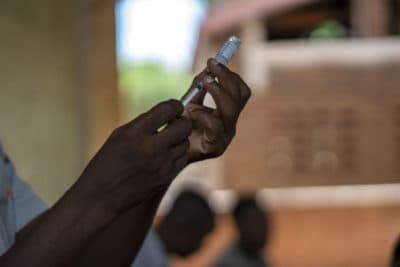 Health officials prepare to vaccine residents of the Malawi village of Tomali, where young children become test subjects for the world's first vaccine against malaria on Dec. 11, 2019. (Jerome Delay/AP/File)